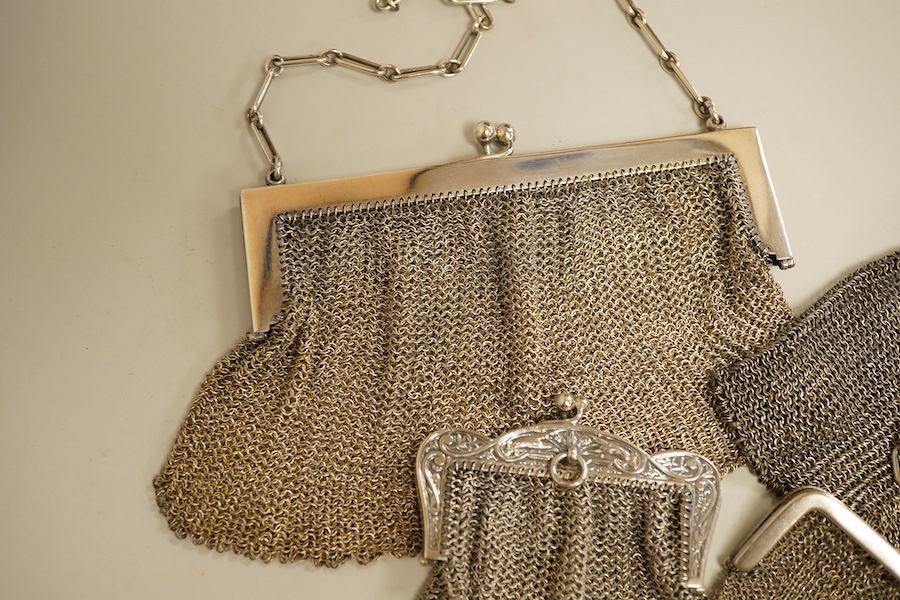 A George V silver mesh evening bag, import marks for Paul Ettlinger, London, 1932, a similar small evening purse, import marks for London, 1919 and two other white metal mesh evening bags or purses, one stamped sterling.